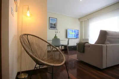 a living room with a couch and a chair at 2F. El mejor lugar para descansar y vivir Ourense in Ourense