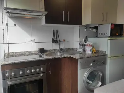 a kitchen with a sink and a washing machine at 2F. El mejor lugar para descansar y vivir Ourense in Ourense
