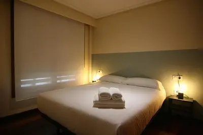 a bedroom with a bed with two towels on it at 2F. El mejor lugar para descansar y vivir Ourense in Ourense
