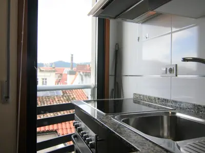 a kitchen with a sink and a large window at 2F. El mejor lugar para descansar y vivir Ourense in Ourense
