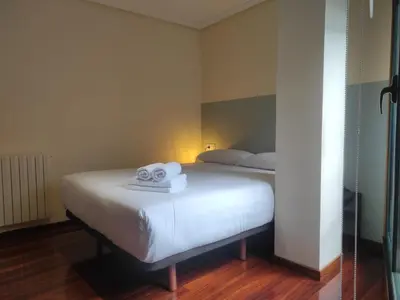 a bedroom with a bed with towels on it at 3B.Descansa y disfruta en el corazón de las Burgas in Ourense