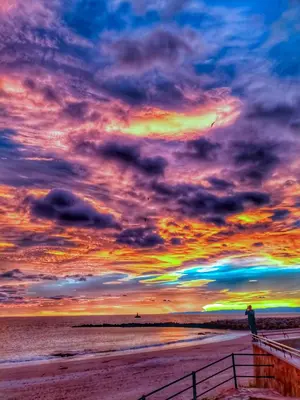 a sunset on a beach with a cloudy sky at Casa Fernando in Burela de Cabo