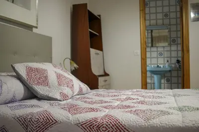 a bed with two pillows on it in a room at Casa Fernando in Burela de Cabo