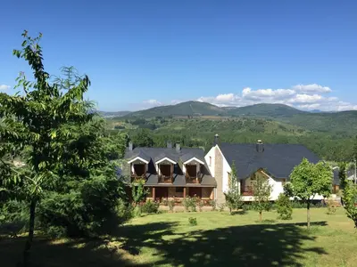 an image of a house with mountains in the background at Hotel Rural Casa Ana in Vega de Espinareda