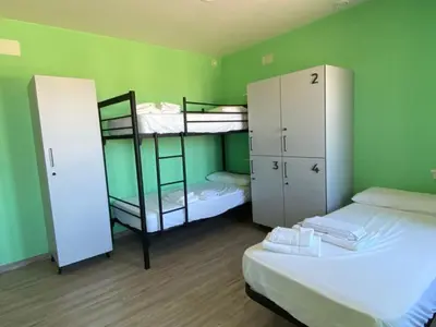two bunk beds in a room with green walls at O TEU SITIO in Ribadeo