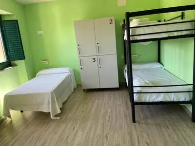 a bedroom with two bunk beds and a closet at O TEU SITIO in Ribadeo