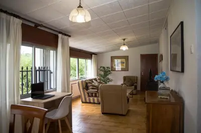 a living room with a couch and a table at LA CASA DEL RÍO - A 13 kilómetros de Santiago in Sigüeiro