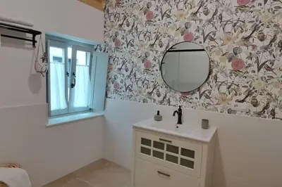 a bathroom with a sink and a mirror at A Maraxe in Rinlo