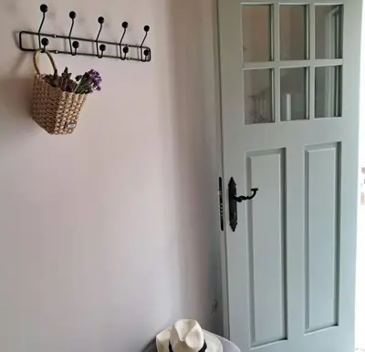 a door with a basket of flowers on the wall at A Maraxe in Rinlo
