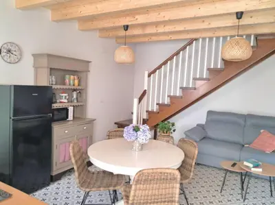 a living room with a table and a couch at A Maraxe in Rinlo