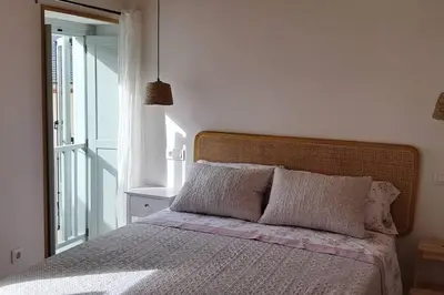 a bedroom with a bed with a large window at A Maraxe in Rinlo
