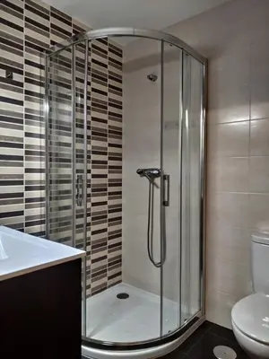 a bathroom with a shower with a sink and a toilet at Casa Nicolas in Chantada
