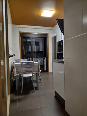 a kitchen and dining room with a table and chairs at Casa Nicolas in Chantada
