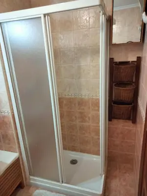 a shower with a glass door in a bathroom at Apartamento Laguna in Ribadeo