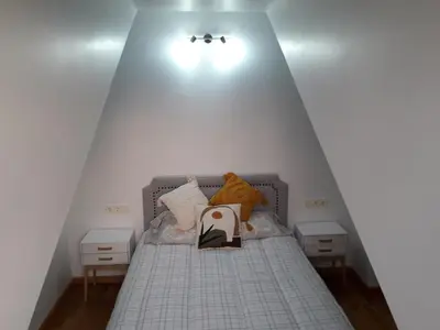 a bedroom with a bed with two night stands and two draws at TEMPLE in Ponferrada