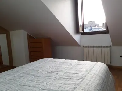 a bedroom with a white bed and a window at TEMPLE in Ponferrada