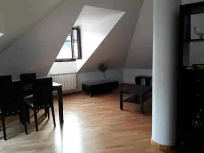 a dining room with a table and chairs in a attic at TEMPLE in Ponferrada