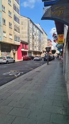 a city street with cars parked on the street at San Roque Lucus Confort in Lugo