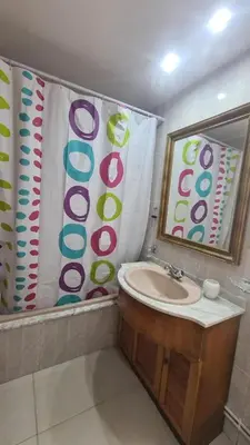 a bathroom with a sink and a shower curtain at San Roque Lucus Confort in Lugo