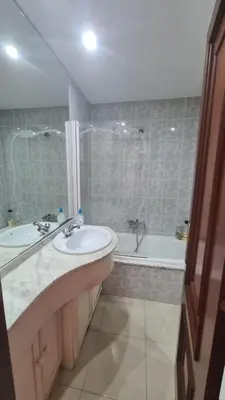 a bathroom with two sinks and a shower and a tub at San Roque Lucus Confort in Lugo
