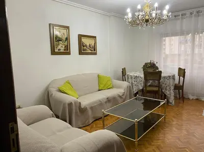 a living room with a couch and a table at Piso Doniz in Ourense
