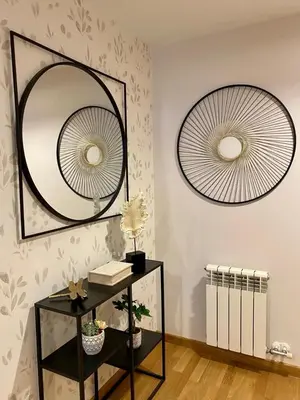 a room with two mirrors on the wall and a table at Andainas G in Milladoiro
