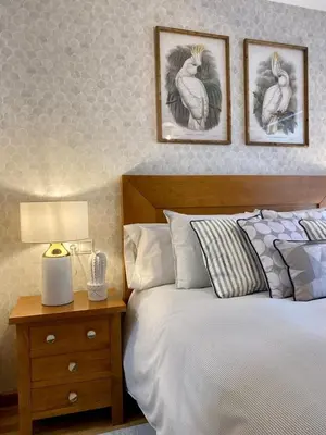 a bedroom with a bed and two pictures on the wall at Andainas G in Milladoiro