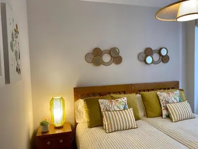 a bedroom with a bed with pillows and a lamp at Andainas B in Milladoiro