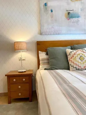 a bedroom with a bed and a lamp on a nightstand at Andainas B in Milladoiro