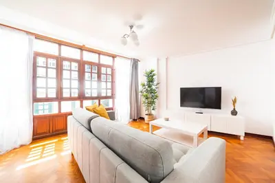 a living room with a couch and a tv at Apartamento Carmiña in Puentedeume