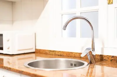 a kitchen counter with a sink in a kitchen at Apartamento Carmiña in Puentedeume