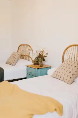 two beds sitting next to each other with a table between them at Casa do Cuco - Rural house in Friol