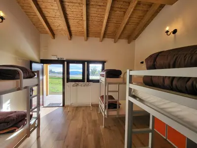 a room with a bunch of bunk beds in it at Albergue Los Hospitales in Colinas de Arriba