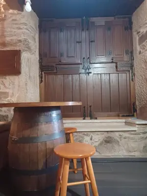 a bar with a table and a stool and a barrel at Casanova1914 in Villatuge