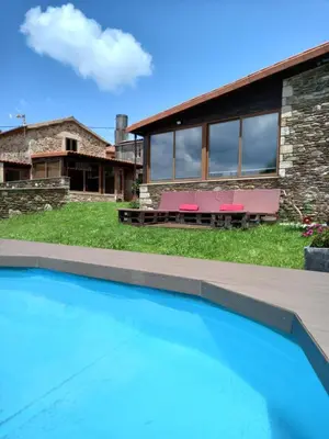 a house with a swimming pool in front of a house at Casanova1914 in Villatuge