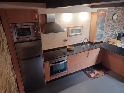a kitchen with a stainless steel refrigerator and a sink at Casanova1914 in Villatuge
