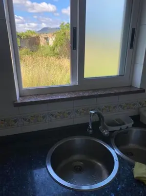 a stove top oven in a kitchen with a sink at Bajo Loft con cocina y baño separados in Cillero