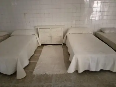 a white bathroom with a sink and a mirror at Bajo Loft con cocina y baño separados in Cillero