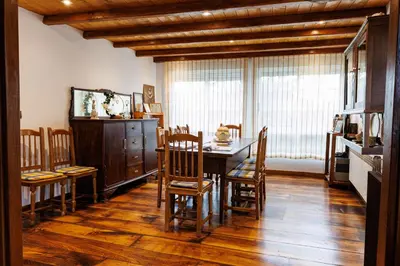a dining room with a wooden table and chairs at Agradable casa de aldea en un entorno natural in Layosa