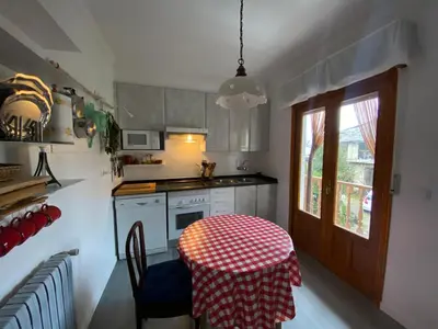 a kitchen with a table with a red and white table cloth at Casa Prada en Sanabria in Sotillo de Sanabria