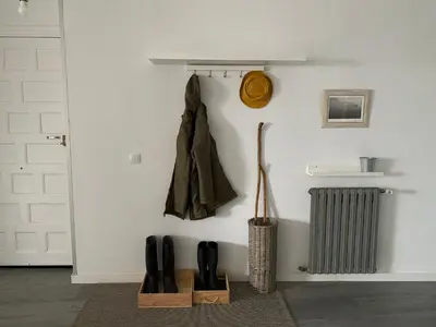 a room with a wall with a coat and a radiator at Casa Prada en Sanabria in Sotillo de Sanabria