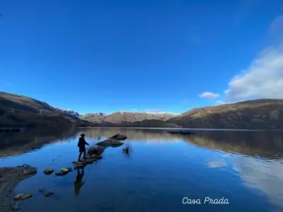 a person standing on a rock in a body of water at Casa Prada en Sanabria in Sotillo de Sanabria