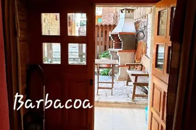 an open door to a patio with a stove at zentralclub La Osera visionando la naturaleza in Santiago del Hermo