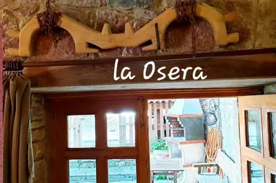 a sign on the door of a building at zentralclub La Osera visionando la naturaleza in Santiago del Hermo