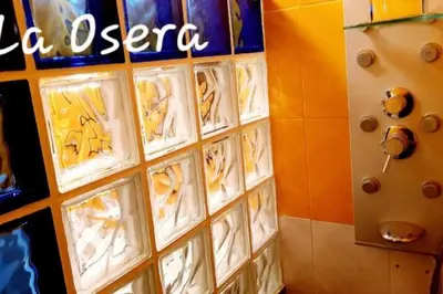 a wall with a bunch of signs on it at zentralclub La Osera visionando la naturaleza in Santiago del Hermo