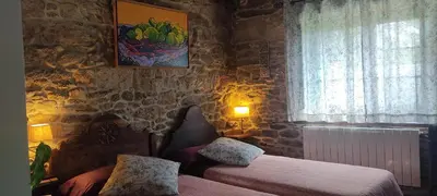 a bedroom with two beds and a window at WITERICUS hospedaxe in Guitiriz