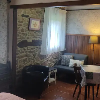 a living room with a couch and a table at WITERICUS hospedaxe in Guitiriz