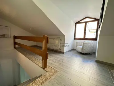 a room with a staircase and a living room at A morada das Camelias in Ourense