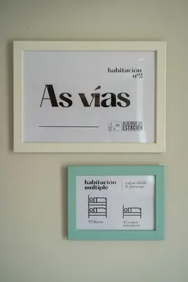 a picture frame with a sign on a wall at Albergue de Cerceda in Cerceda