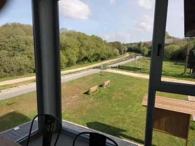 a view from a window of a park with benches at Albergue de Cerceda in Cerceda